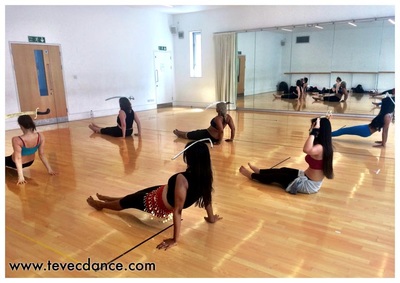 class participants learning bellydance floorwork with sword at The Place, Central London