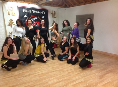 women posing for picture at the end of bellydance class