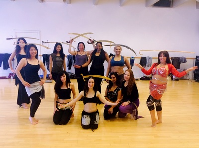happy female class participants at the end of bellydance sword workshop